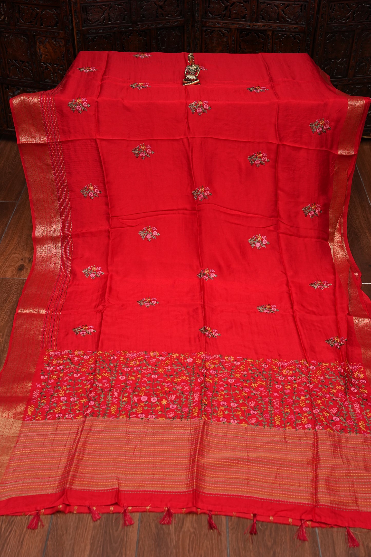 Bright Red Crepe silk saree with French knot work.