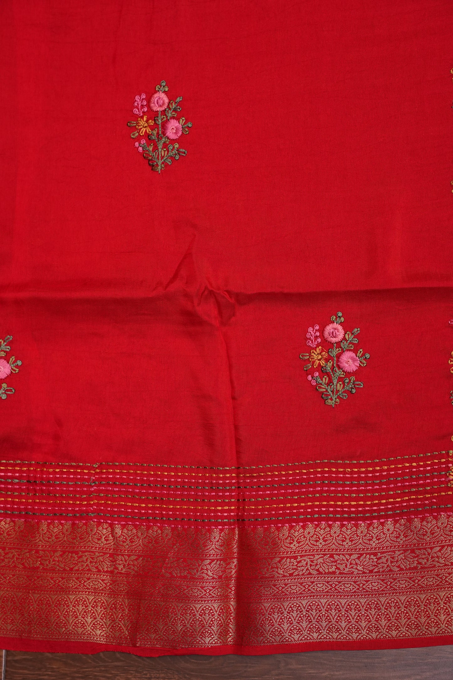 Bright Red Crepe silk saree with French knot work.