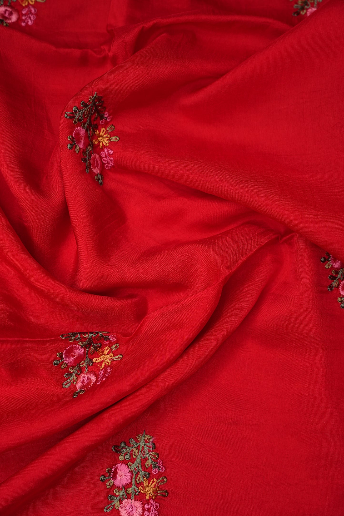 Bright Red Crepe silk saree with French knot work.